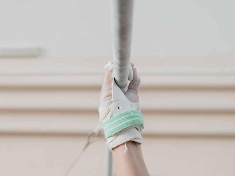 Close up of a man's hands gripping a bar.