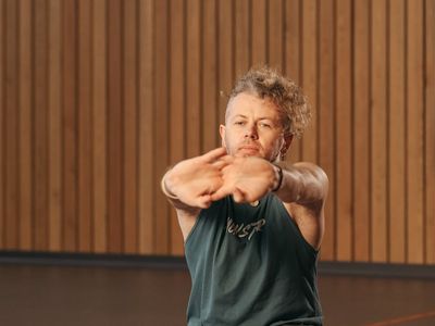Man stretching after a workout in a loft space.